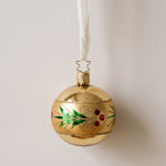 Gold mouth-blown glass ornament with a glittered red and green holly wreath, by Inge-Glas of Lauscha, Germany