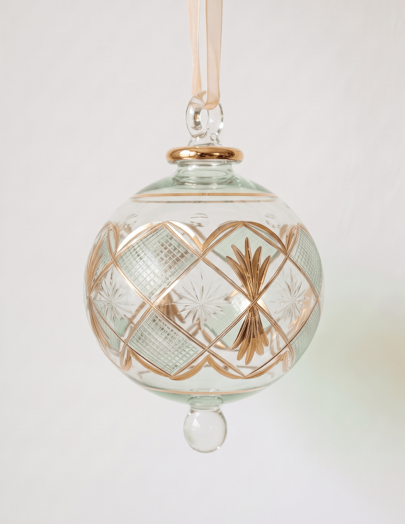 Large hand-blown green glass bauble with a gold checkered pattern, made in Old Cairo, Egypt