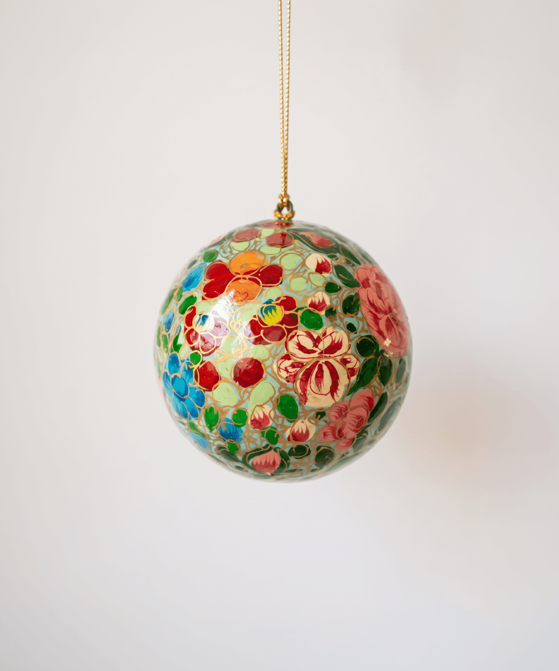 Papier-mache Christmas ornament hand-painted in Kashmir with intricate multicoloured florals