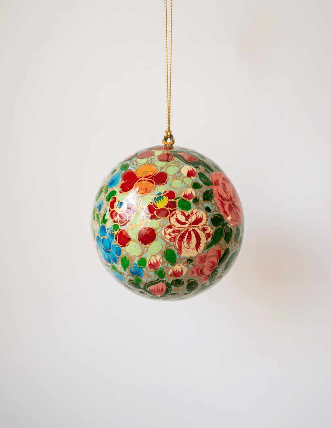 Papier-mache Christmas ornament hand-painted in Kashmir with intricate multicoloured florals