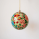 Papier-mache Christmas ornament hand-painted in Kashmir with intricate multicoloured florals