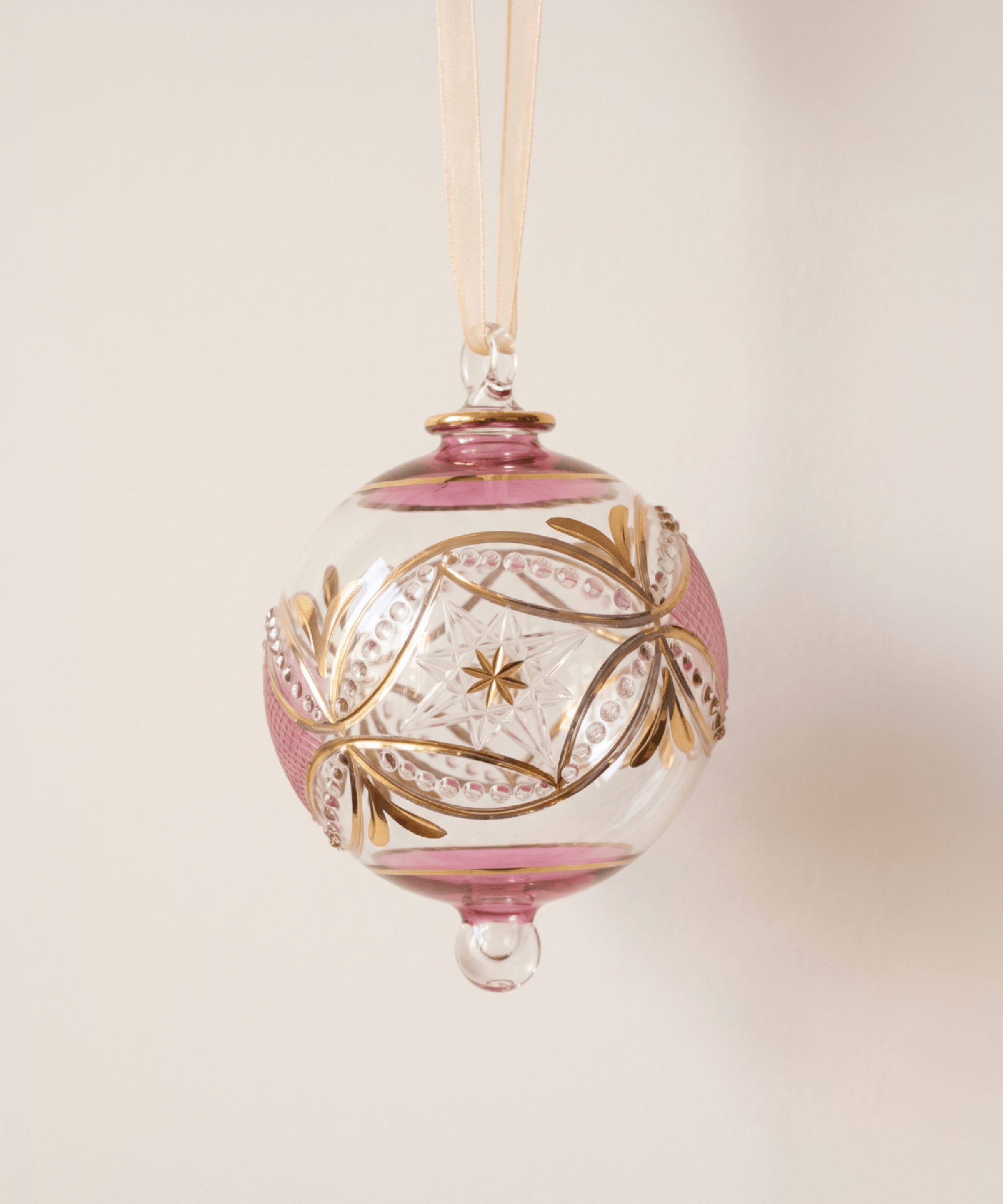 Hand-blown pink glass bauble circled with 14kt gold carousel bands, made in Old Cairo, Egypt