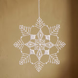 White Plauen lace six-point snowflake ornament with a diamond point design, made in Plauen, Germany