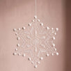 Six-point white Plauen lace snowflake ornament with dotted strands, made in Plauen, Germany