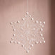 Six-point white Plauen lace snowflake ornament with dotted strands, made in Plauen, Germany