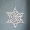 White Plauen lace star ornament with a bell design at the centre, made in Plauen, Germany