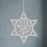 White Plauen lace star ornament with a bell design at the centre, made in Plauen, Germany