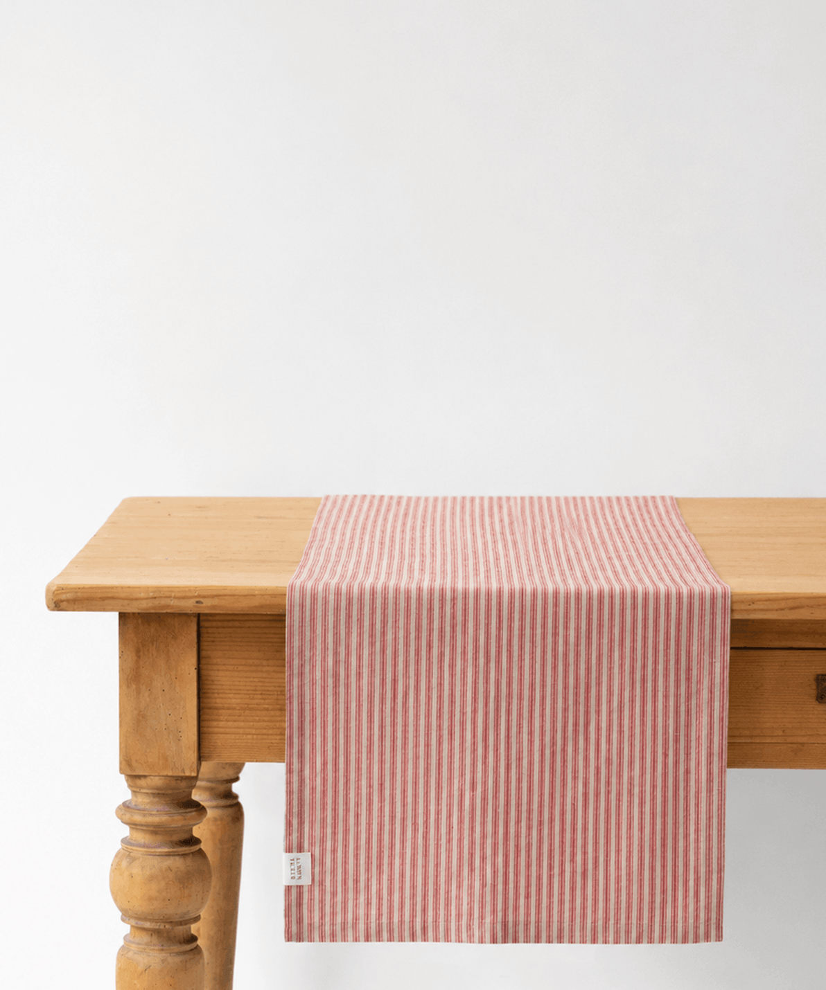 Natural linen table runner with red stripes, stone-washed and woven in Lithuania