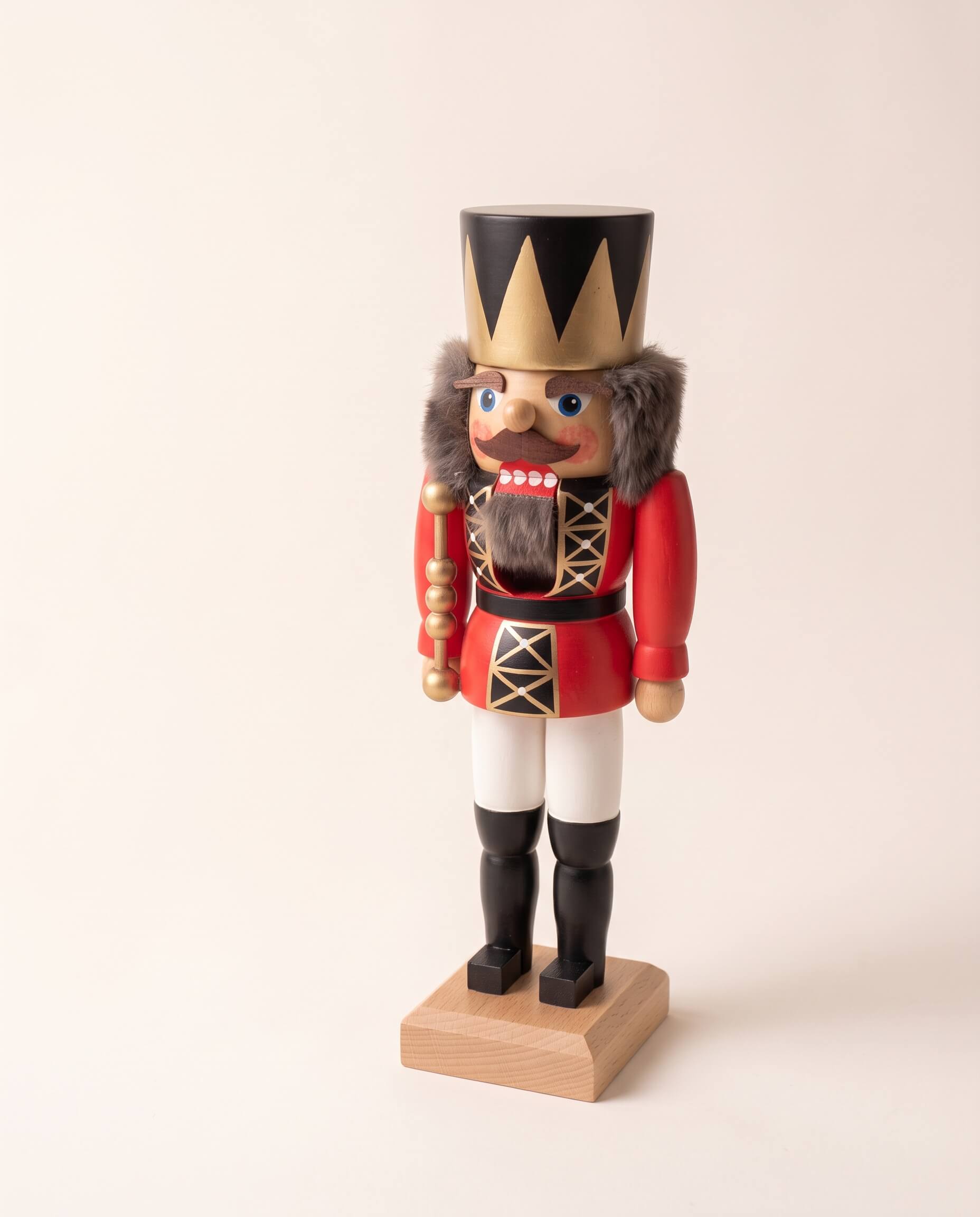 Red and gold hand-painted wooden nutcracker king with a crown, made in Seiffen, Germany