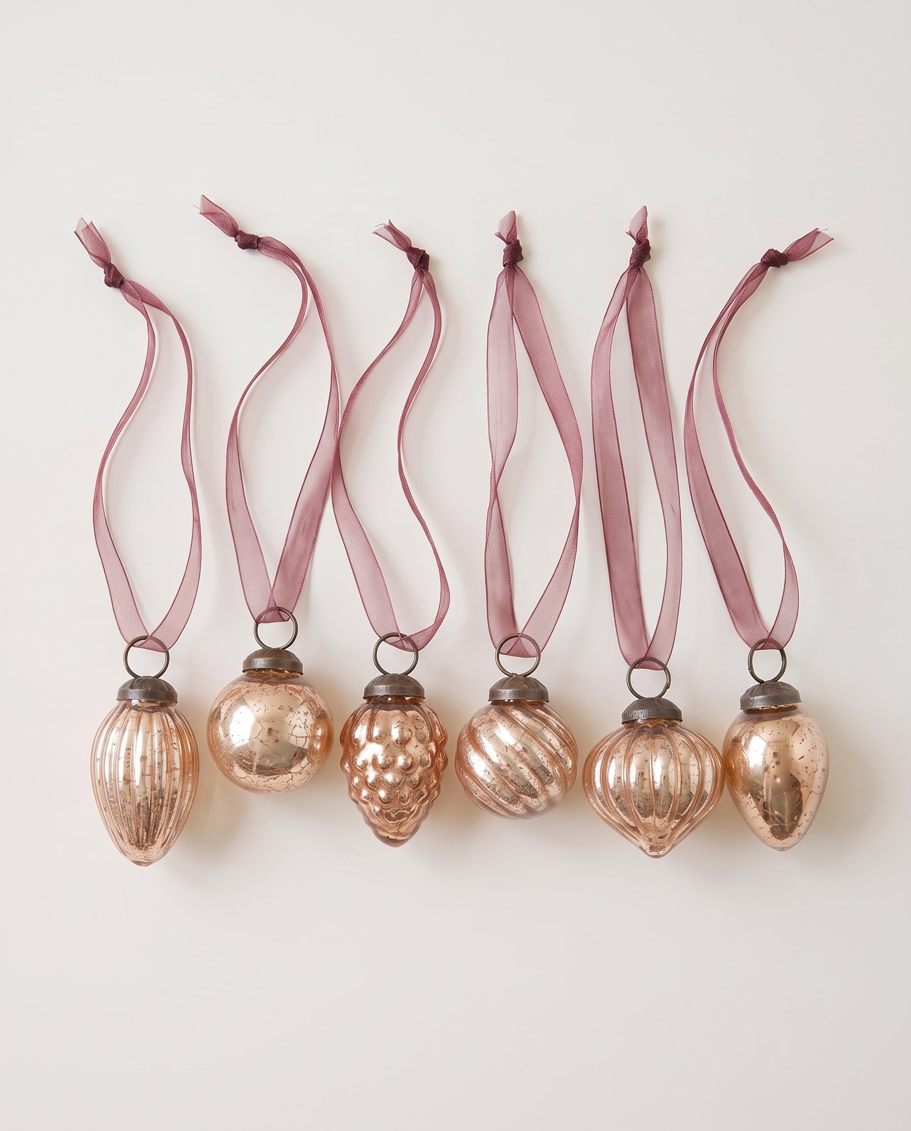 Set of six rose crackle glass Christmas baubles with bronze caps and ribbon hangers, made in India