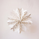 White paper cut snowflake ornament with a cotton hanger, inspired by Scandinavian paper craft
