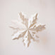 Handmade white paper cut snowflake ornament in a Scandinavian design, with a cotton hanger