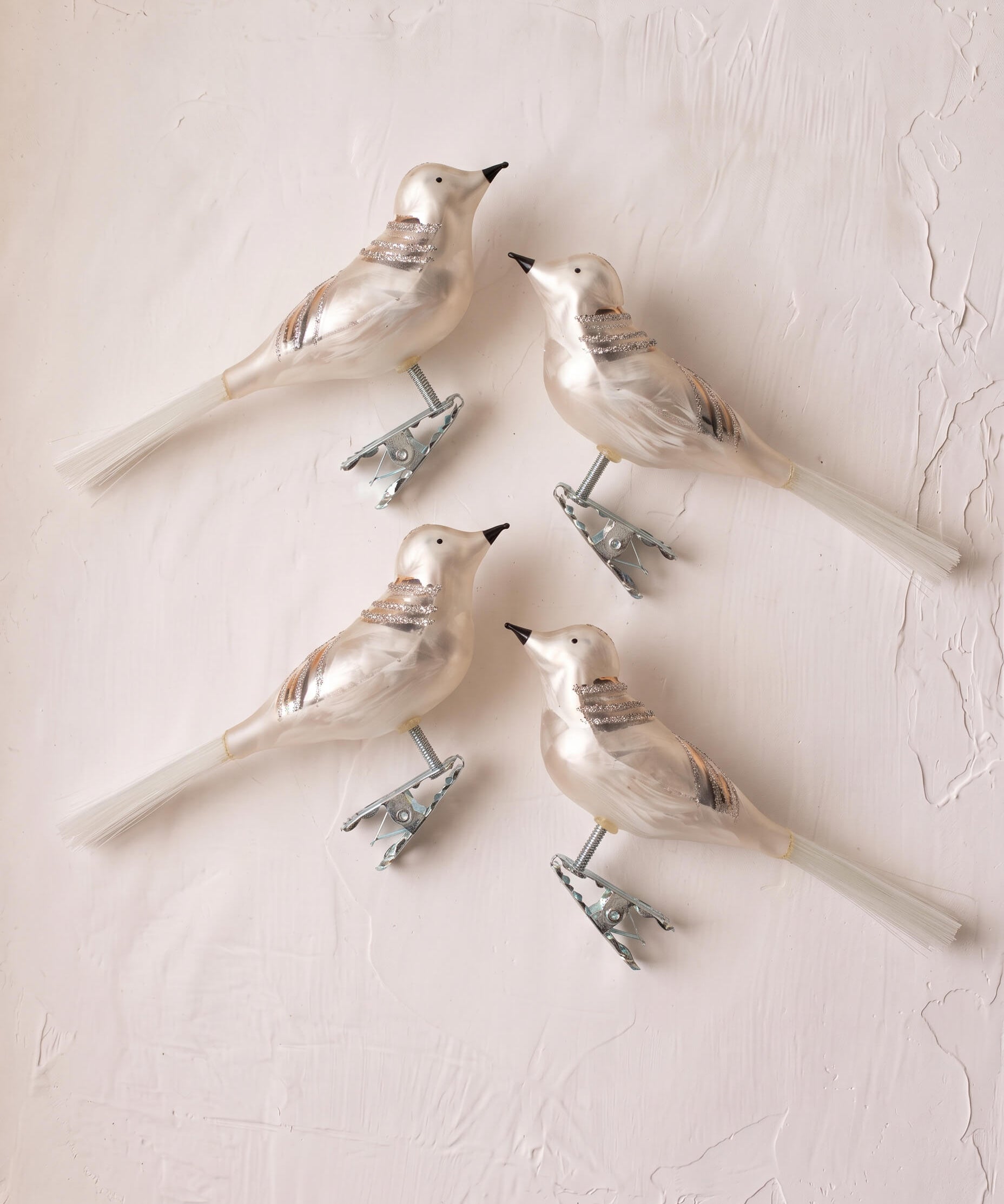 Set of four white mouth-blown glass bird ornaments with glitter detail, made in Thuringia, Germany