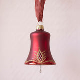 Matte red mouth-blown glass bell ornament with a glittered waffle pattern, made in Thuringia, Germany