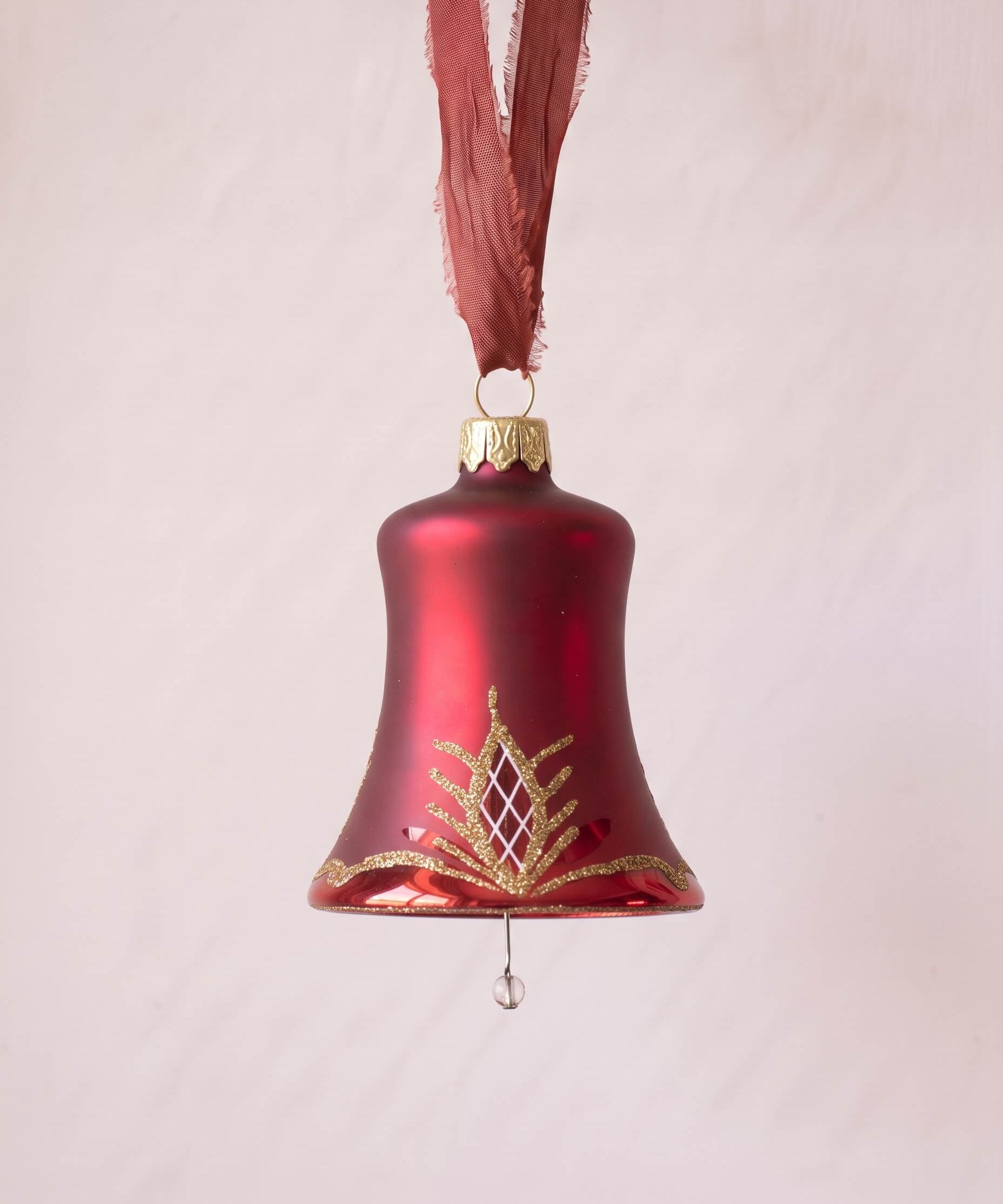 Matte red mouth-blown glass bell ornament with a glittered waffle pattern, made in Thuringia, Germany