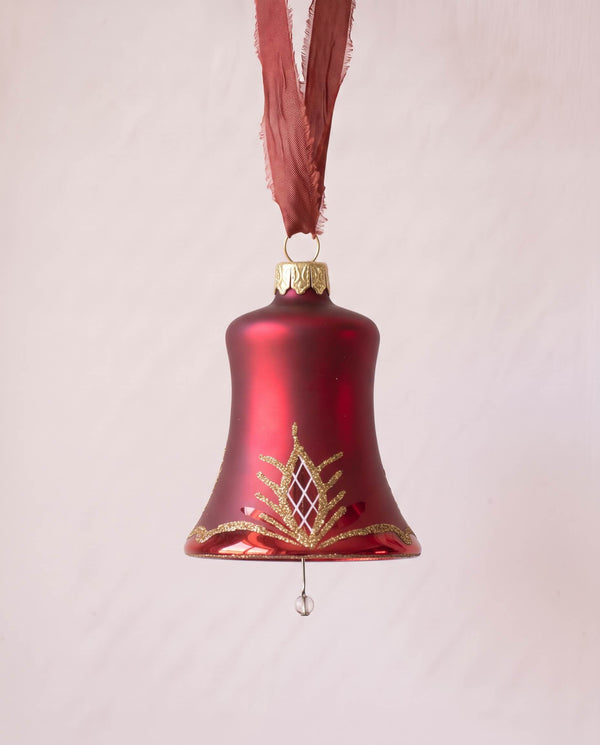 Matte red mouth-blown glass bell ornament with a glittered waffle pattern, made in Thuringia, Germany