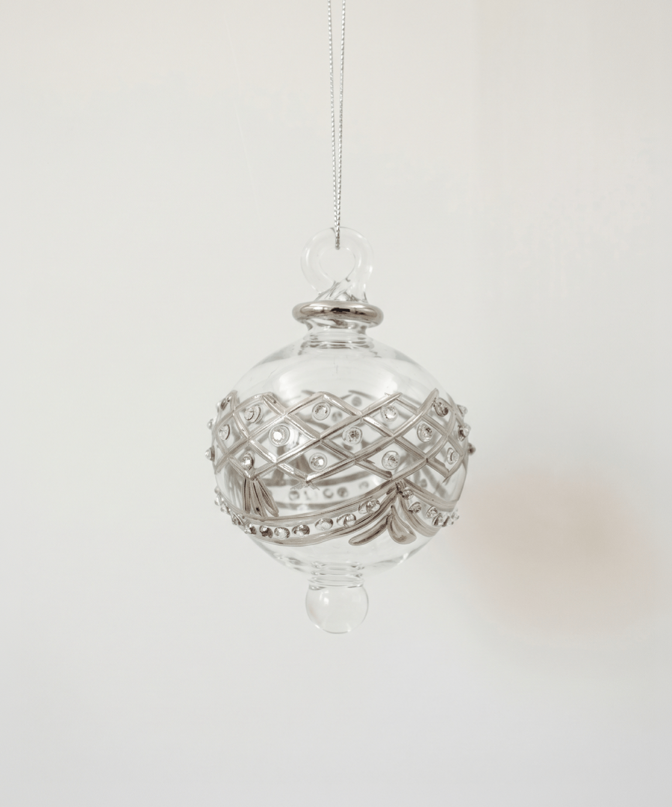 Hand-blown clear glass bauble painted with delicate platinum drapes, made in Old Cairo, Egypt