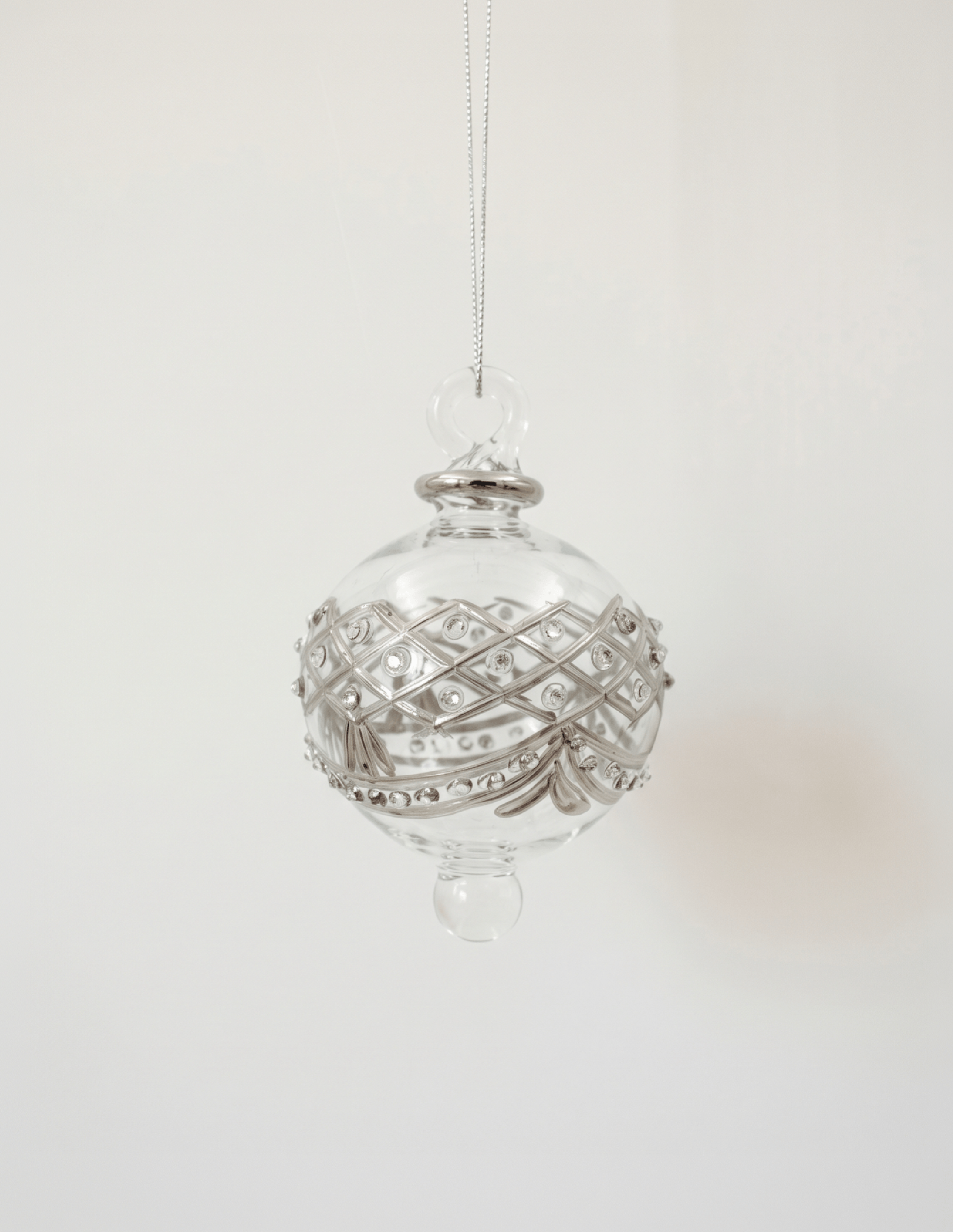 Hand-blown clear glass bauble painted with delicate platinum drapes, made in Old Cairo, Egypt
