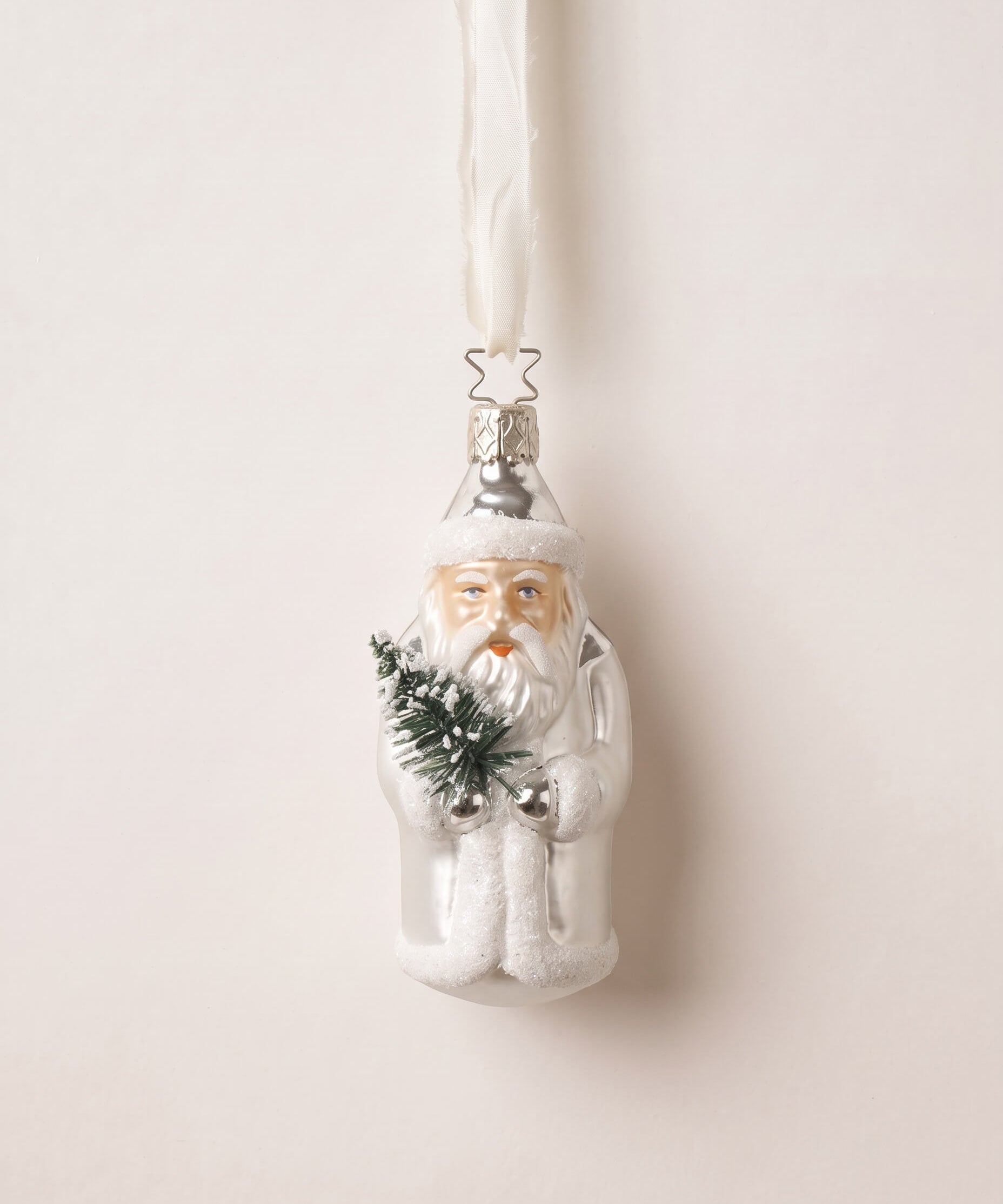 Silver and white mouth-blown glass St. Nicholas ornament holding a small evergreen, by Inge-Glas of Germany