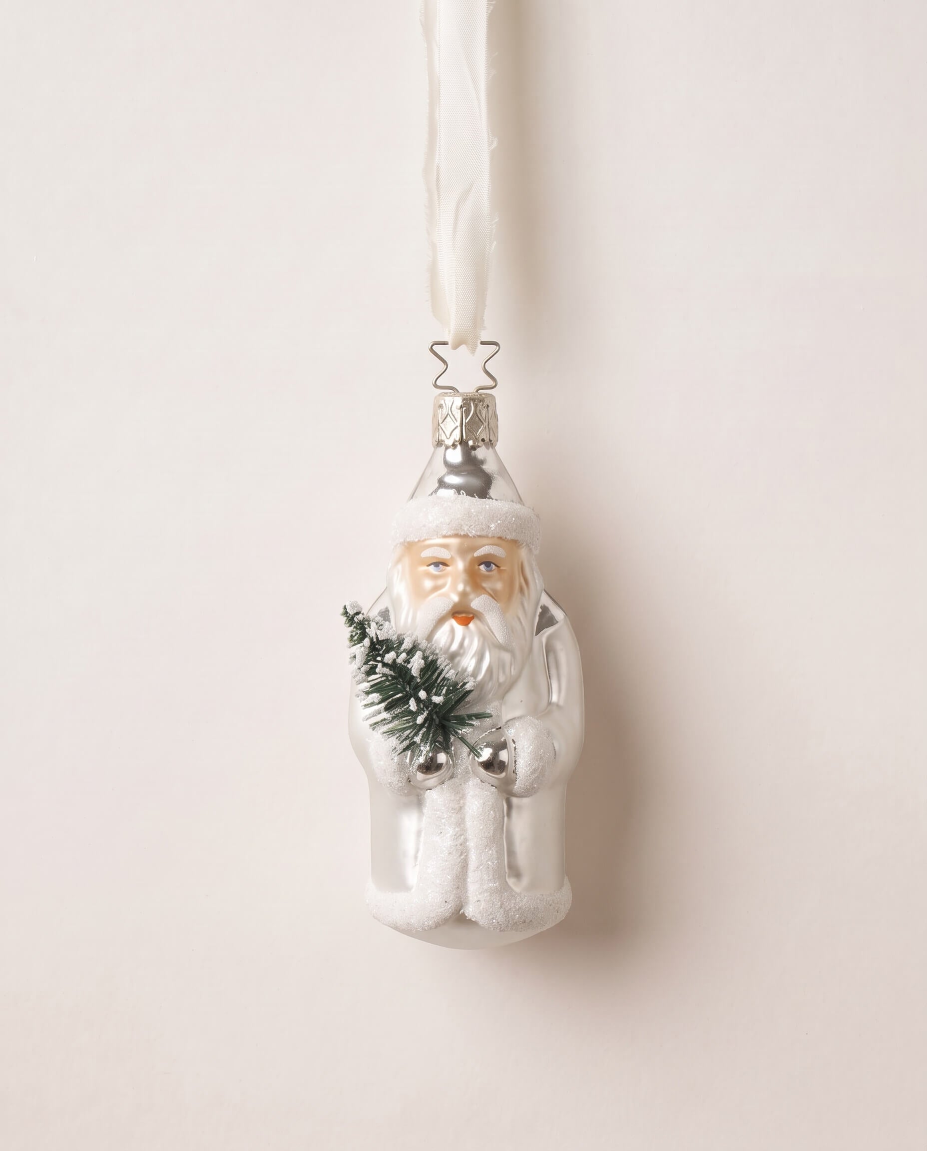 Silver and white mouth-blown glass St. Nicholas ornament holding a small evergreen, by Inge-Glas of Germany