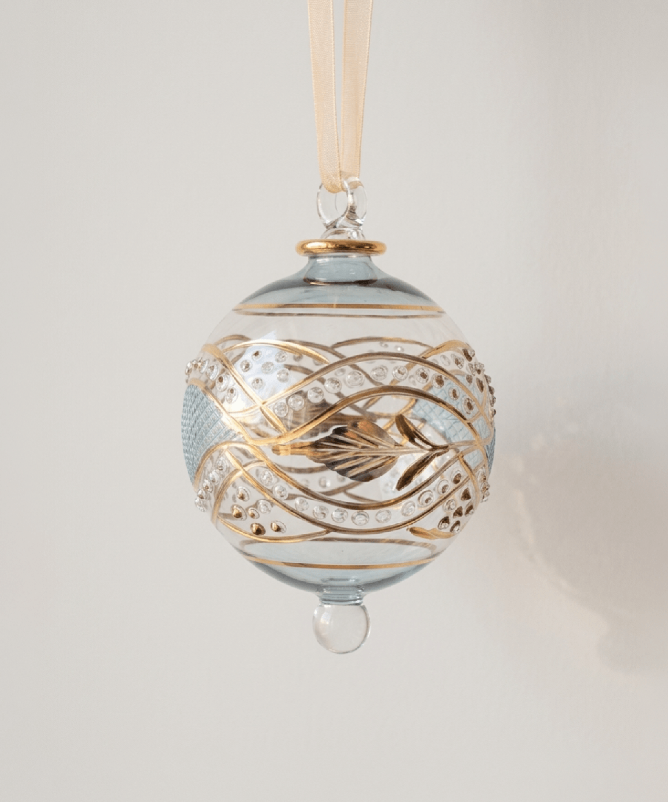 Hand-blown teal glass bauble with an etched floral garland and 14kt gold detail, made in Old Cairo, Egypt