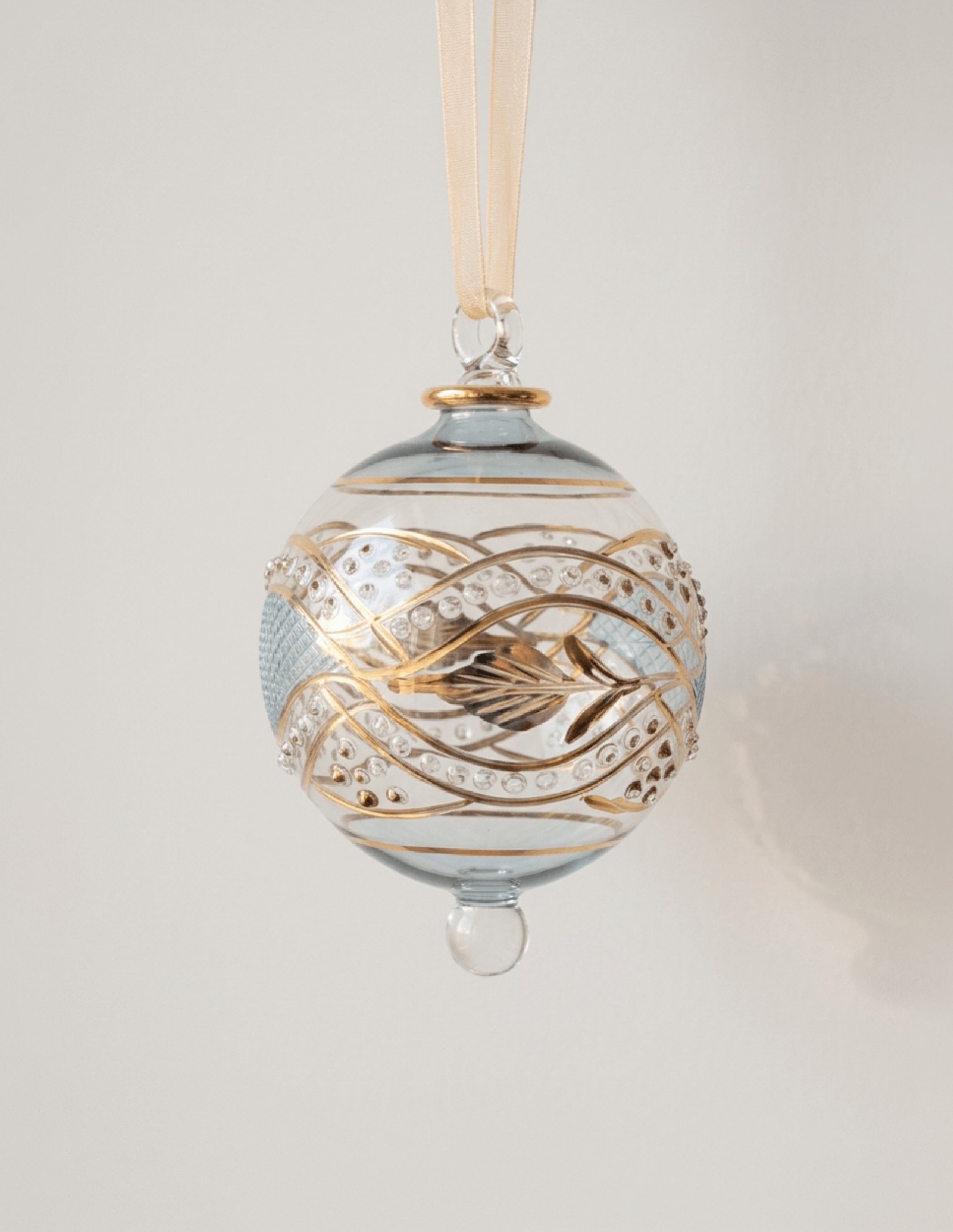 Hand-blown teal glass bauble with an etched floral garland and 14kt gold detail, made in Old Cairo, Egypt