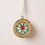 Gold glass reflector ornament with a red and green star centre and gold glitter swirls, by Inge-Glas of Lauscha, Germany