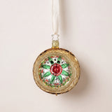 Gold glass reflector ornament with a red and green star centre and gold glitter swirls, by Inge-Glas of Lauscha, Germany