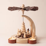 Hand-painted wooden candle pyramid with three children at play among trees, another view