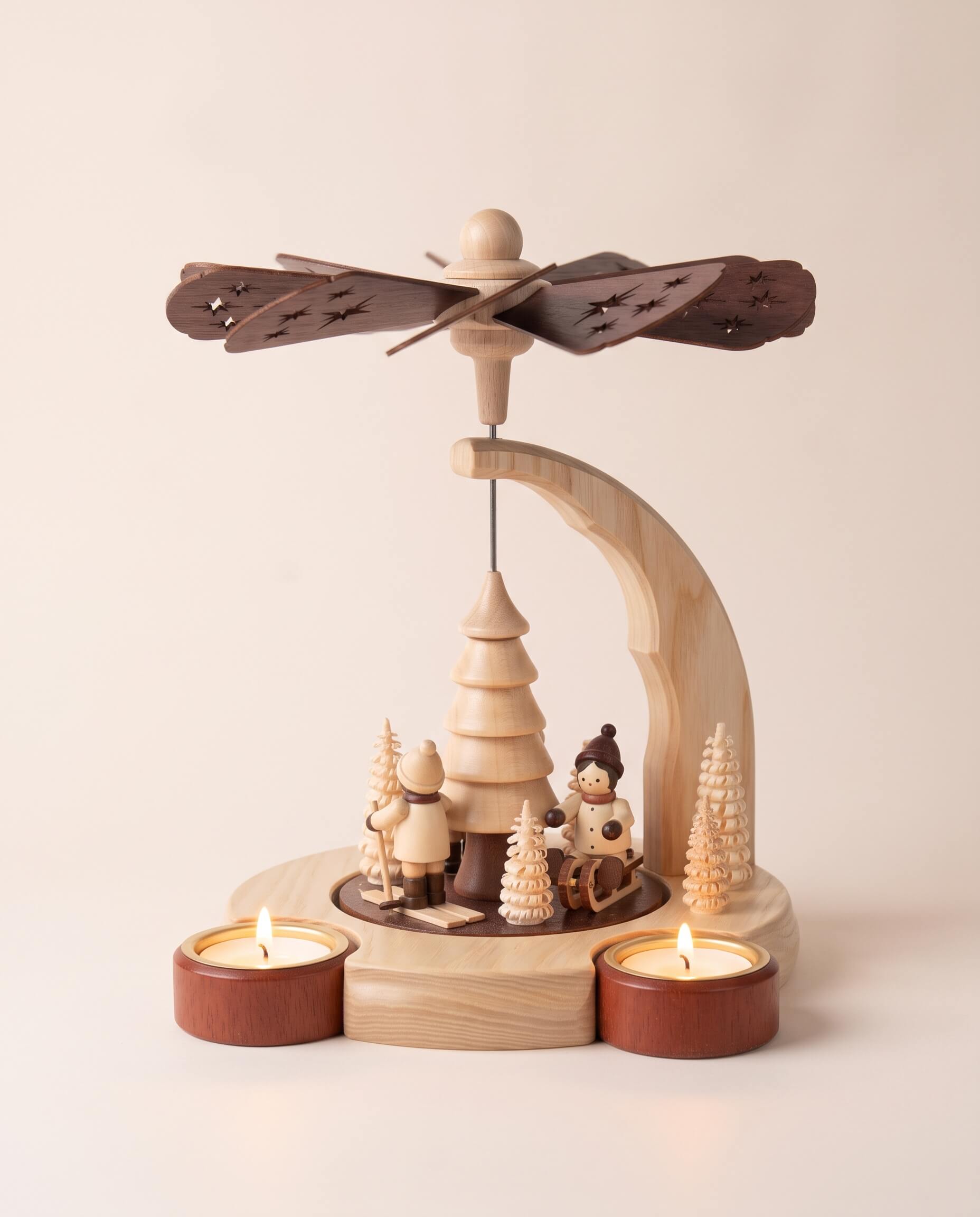 Hand-painted wooden candle pyramid with three children at play among trees, another view