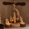 Hand-painted wooden candle pyramid with three children at play among trees, made in Seiffen, Germany