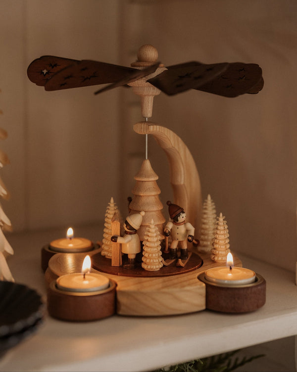 Hand-painted wooden candle pyramid with three children at play among trees, made in Seiffen, Germany