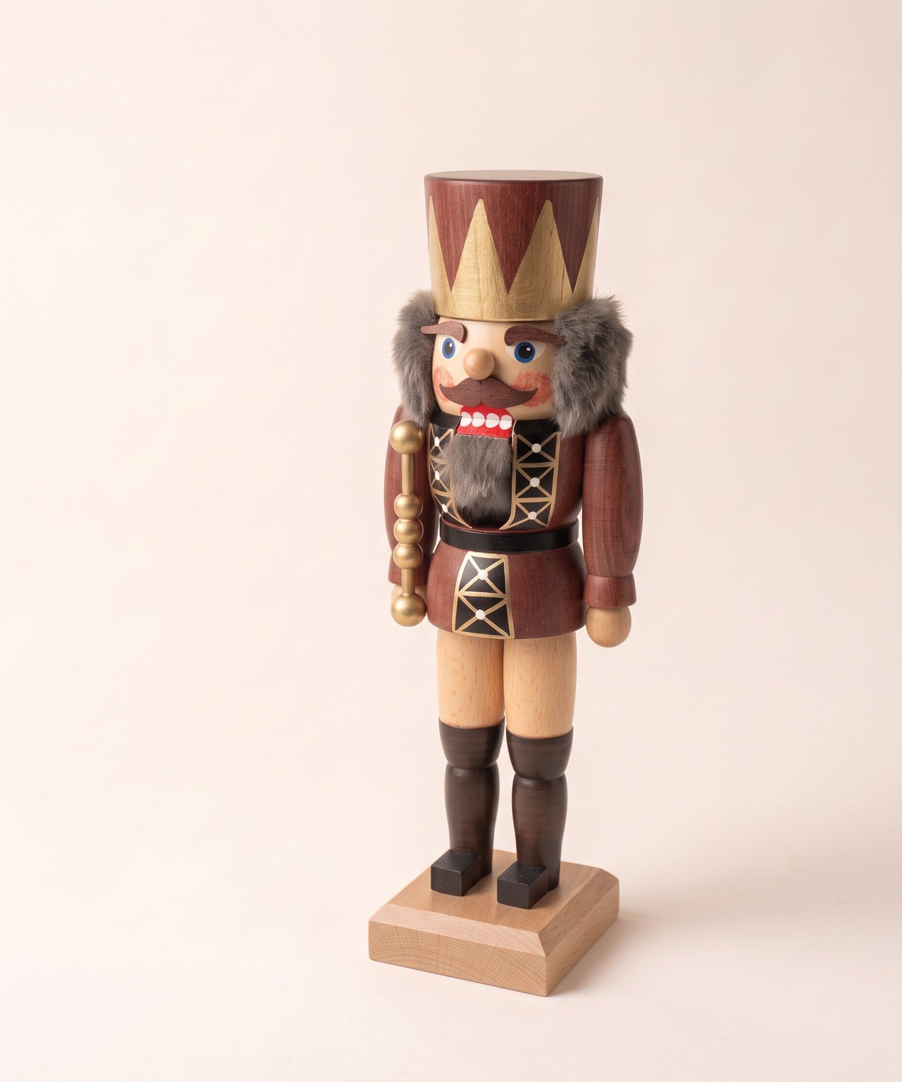 Brown and gold hand-painted wooden nutcracker king with a crown, made in Seiffen, Germany