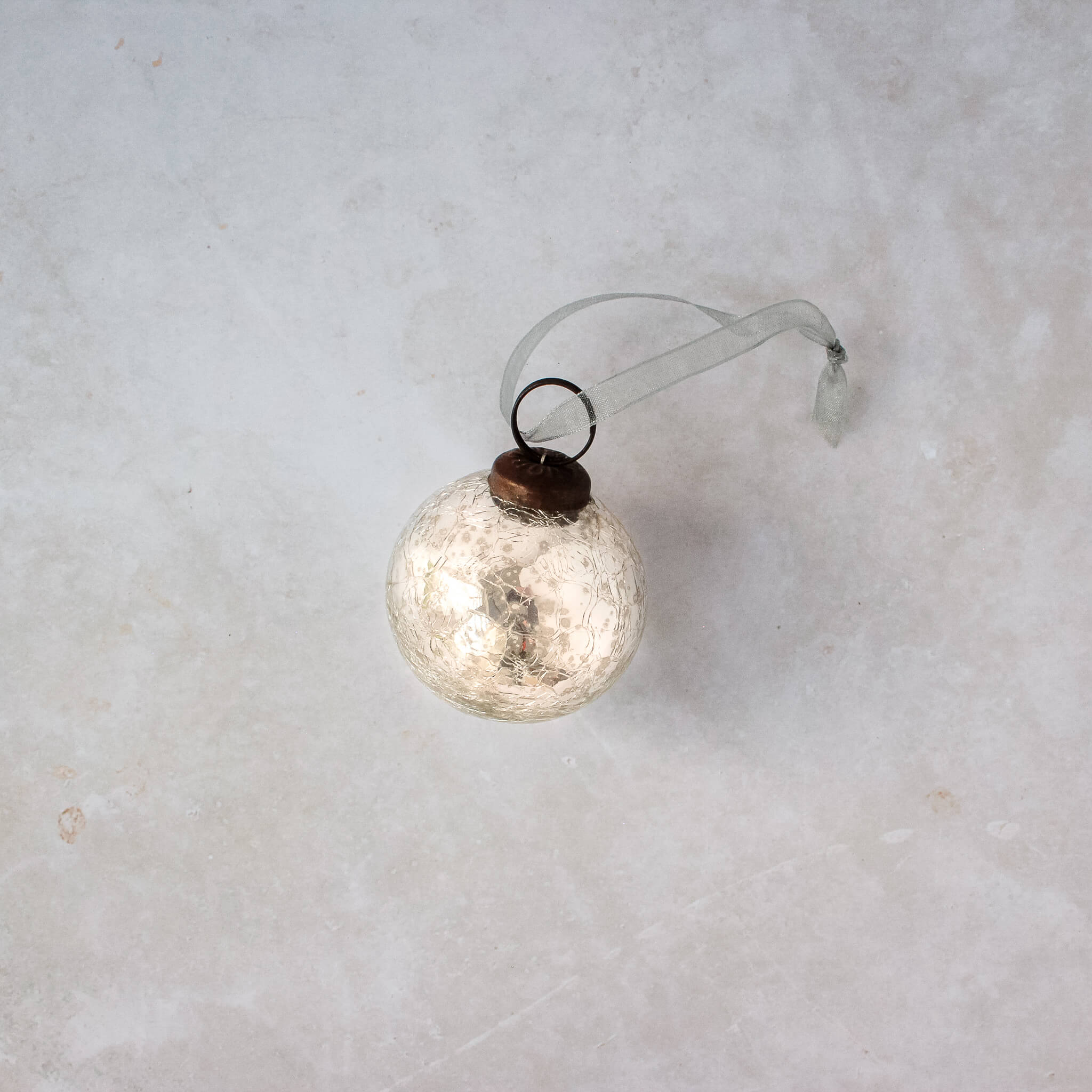 2 inch silver crackle glass Christmas bauble with a bronze cap and ribbon hanger, another view