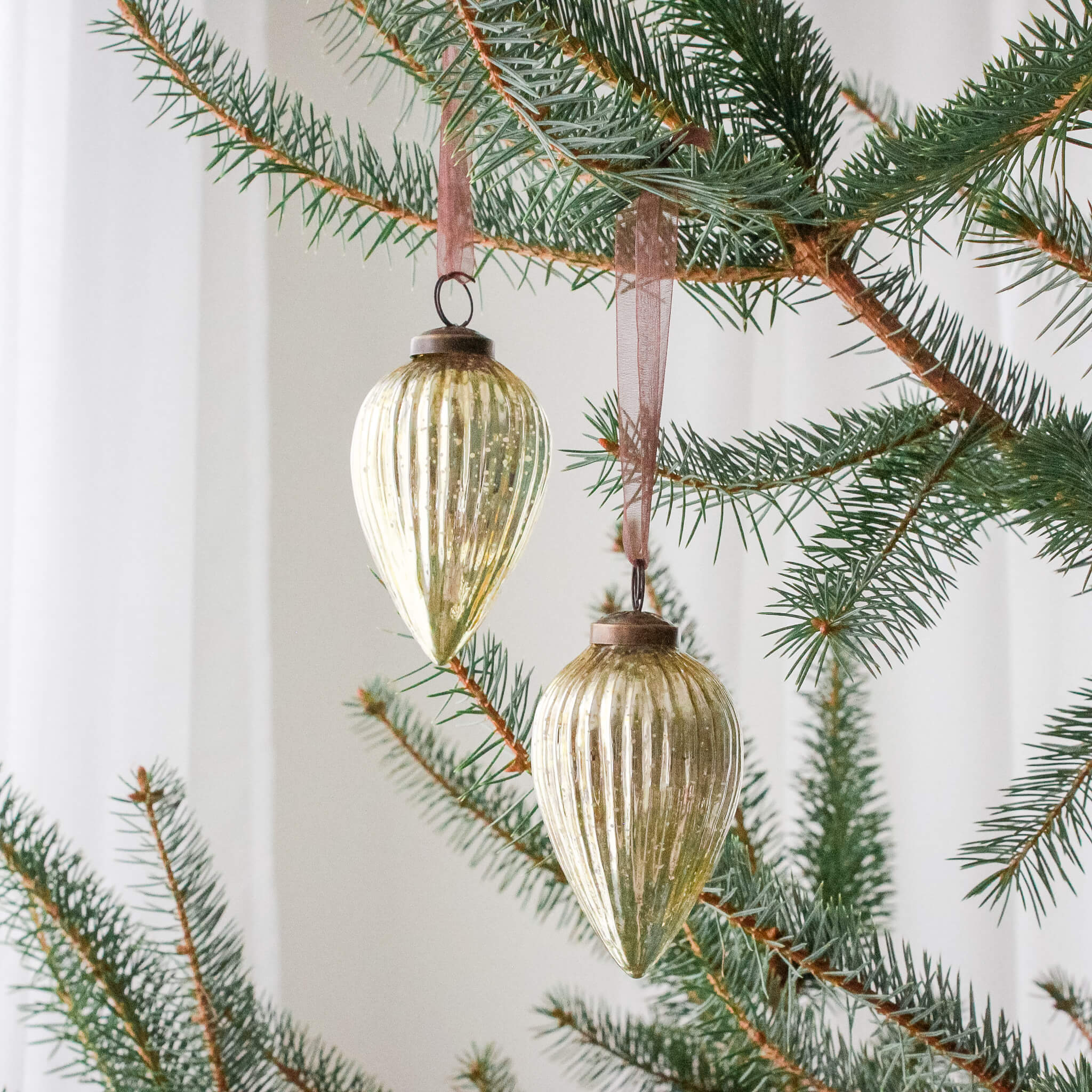 3 inch gold pressed glass pinecone ornament with a bronze cap and ribbon hanger, another view