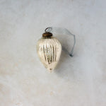 3 inch silver pressed glass pinecone ornament with a bronze cap and ribbon hanger, another view