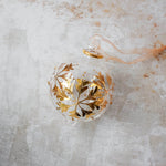 Hand-blown clear glass bauble painted with gold snowflakes, another view