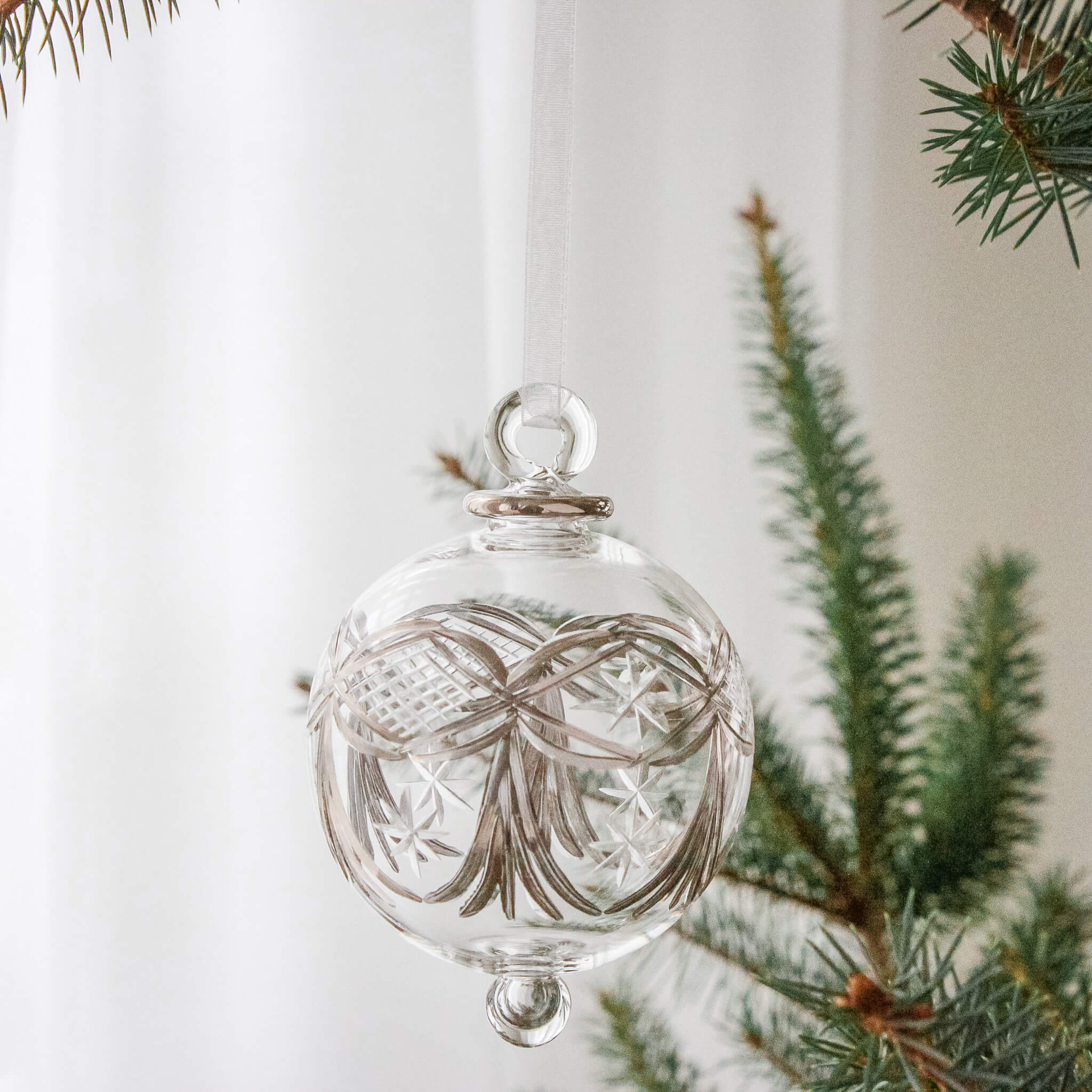 Hand-blown clear glass bauble painted with silver platinum garlands, another view